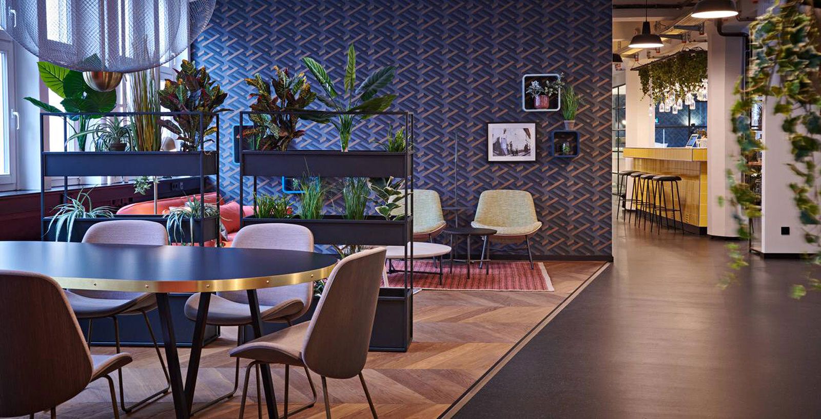 Education-Center in Hamburg - Besprechungstisch aus der Cramer Holzmanufaktur, Stühle Tokai von Pode, Regal Planter Cral von Röshults, Sessel Bettle Lounge Chair von Gubi, Teppich Makkay von Pode.